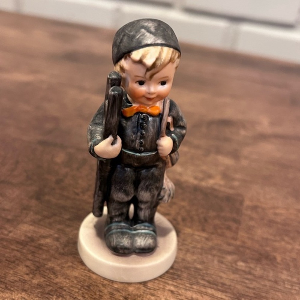 This is a Goebel M.I. Hummel "Chimney Sweep" figurine, model number 12/2/0.
